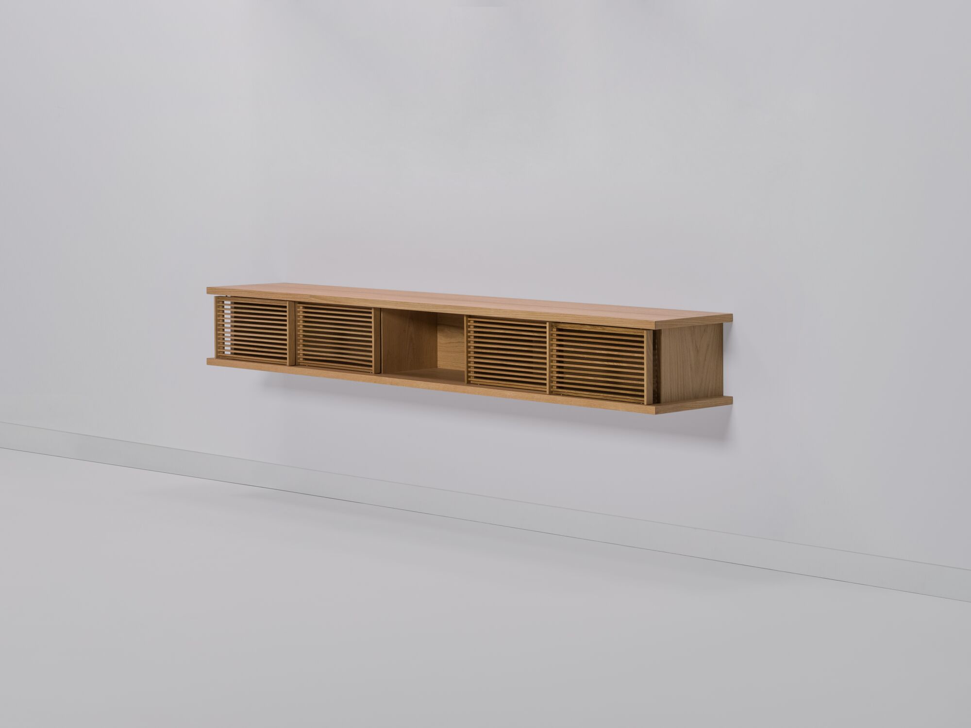 Large oak floating media unit with slatted doors front angle view